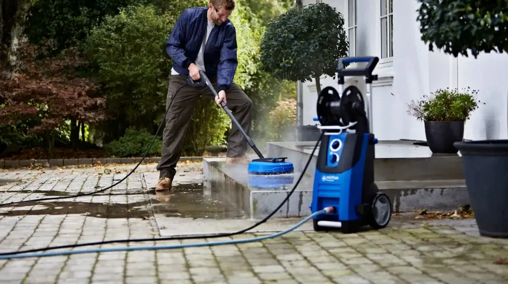 A pressure washer cleaning a concrete patio in Australia