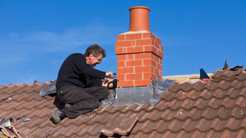Step and apron flashing under the tiles here prevent leaks at the brick chimney